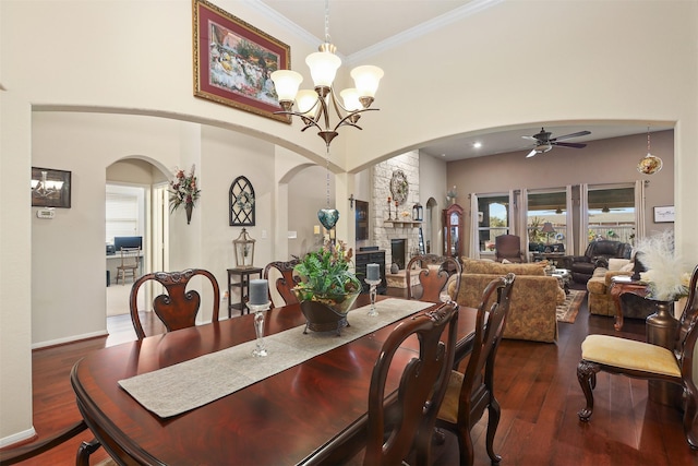 dining space featuring arched walkways, plenty of natural light, and a fireplace