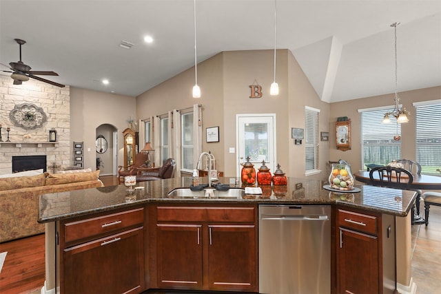 kitchen featuring a sink, ceiling fan, open floor plan, and dishwasher