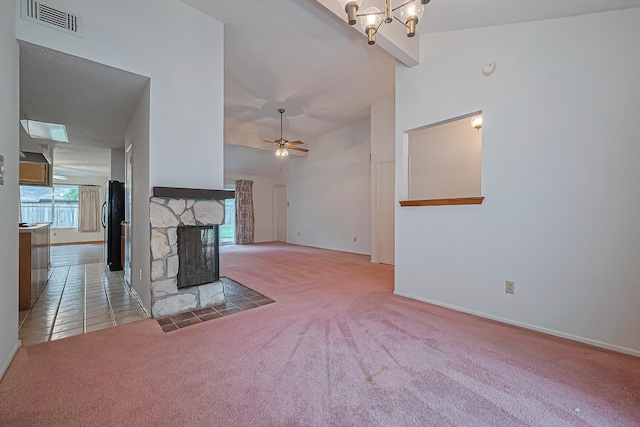unfurnished living room featuring visible vents, a fireplace, baseboards, beamed ceiling, and carpet