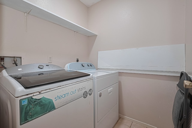 laundry area featuring laundry area, light tile patterned floors, and washing machine and dryer