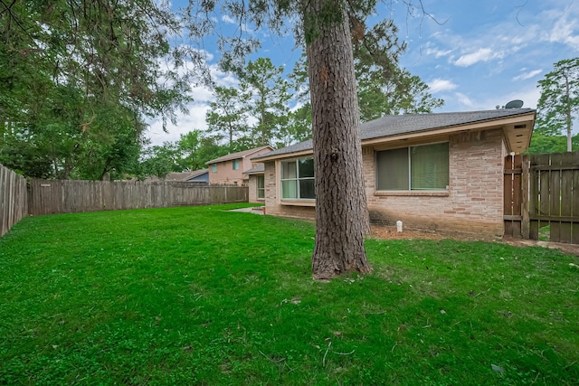 view of yard with a fenced backyard