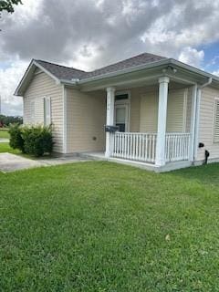 exterior space featuring a yard and covered porch