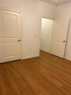unfurnished bedroom featuring baseboards and wood finished floors