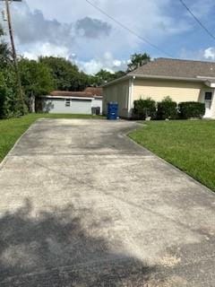 view of home's exterior with a yard and driveway
