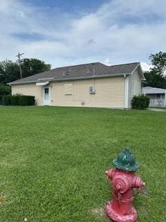 rear view of house with a yard