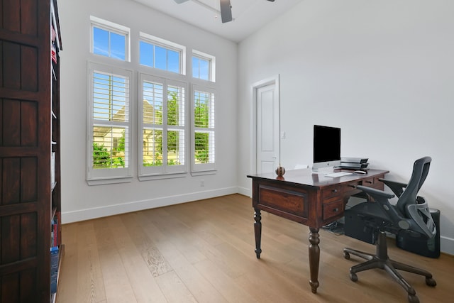 office area featuring baseboards, a ceiling fan, and wood finished floors