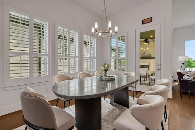 dining room featuring baseboards, an inviting chandelier, and wood finished floors