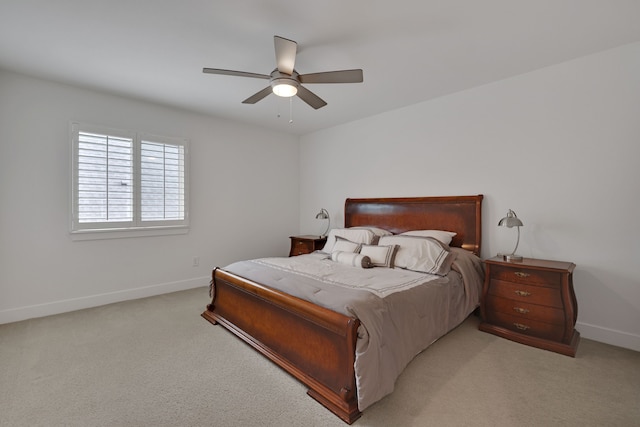 bedroom with baseboards, light carpet, and a ceiling fan