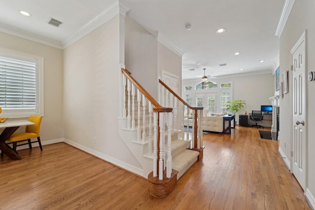 staircase with ceiling fan, recessed lighting, wood finished floors, and visible vents