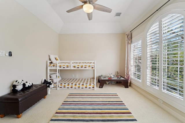 carpeted bedroom with multiple windows, ceiling fan, and visible vents
