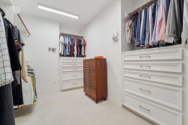 spacious closet featuring light carpet