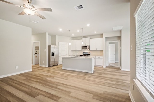 5030 Magnolia Springs Dr, Pearland, TX 77584 - kitchen featuring stainless steel appliances, white cabinetry, light countertops, a ceiling fan, and recessed lighting