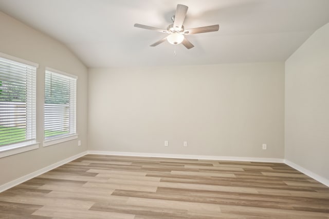 5030 Magnolia Springs Dr, Pearland, TX 77584 - empty room featuring ceiling fan, lofted ceiling, light wood finished floors, and baseboards