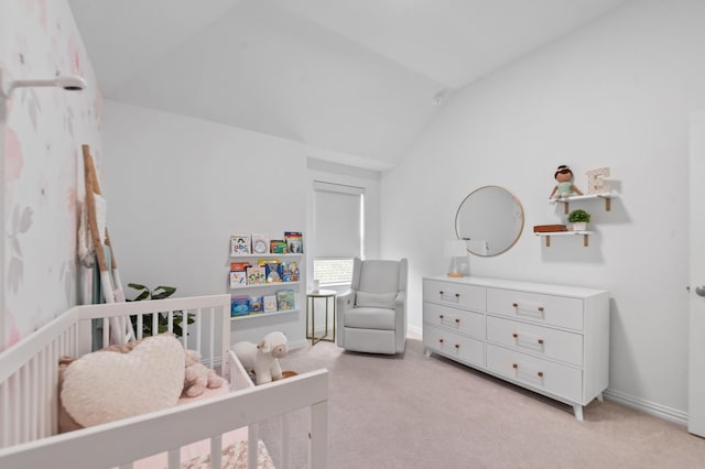 bedroom featuring a nursery area, light colored carpet, vaulted ceiling, and baseboards