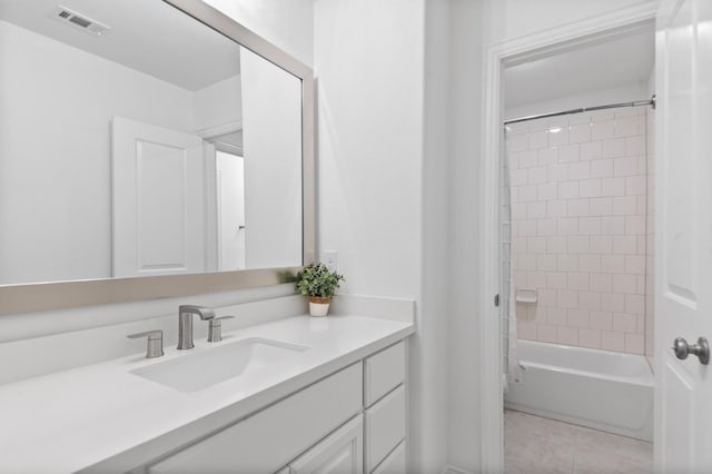 bathroom with tile patterned floors, visible vents, shower / tub combination, and vanity