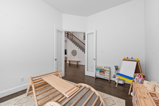bedroom featuring baseboards and wood finished floors