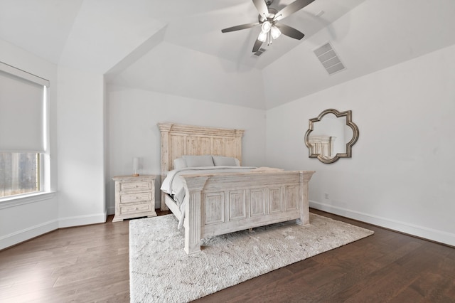bedroom featuring baseboards, visible vents, wood finished floors, and lofted ceiling