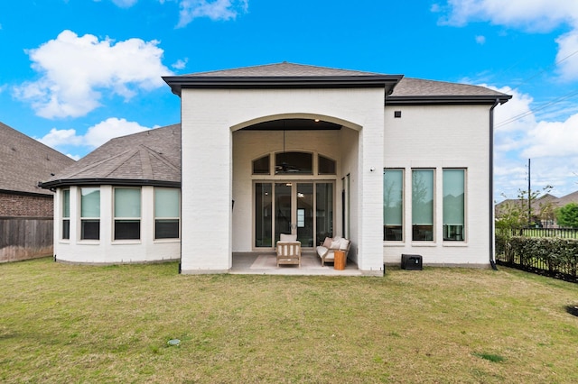 back of house featuring a yard, a patio, a ceiling fan, and a fenced backyard