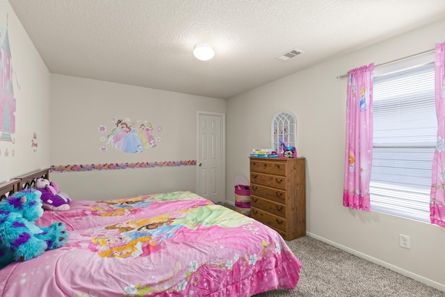 carpeted bedroom featuring a textured ceiling, visible vents, and baseboards
