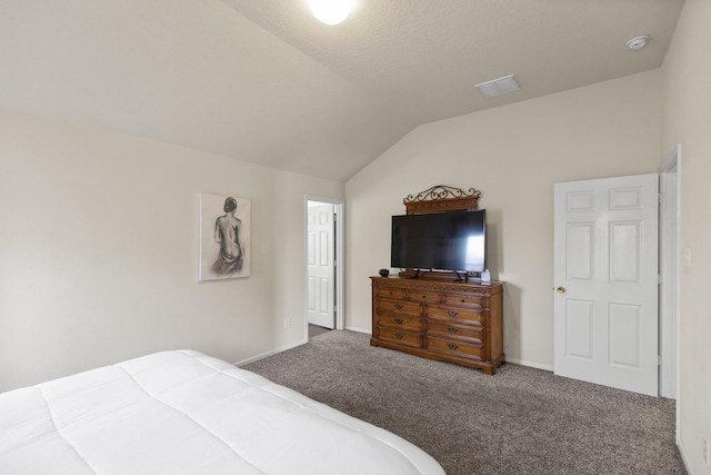 carpeted bedroom with baseboards and vaulted ceiling