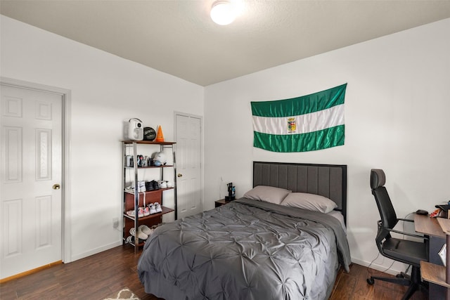 bedroom featuring baseboards and wood finished floors