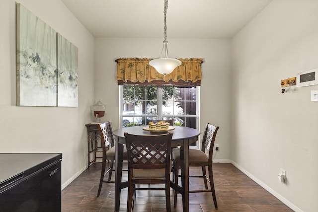 dining room featuring baseboards and dark wood finished floors