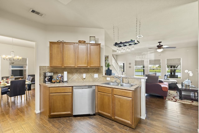 kitchen with stainless steel dishwasher, a sink, light countertops, a peninsula, and open floor plan