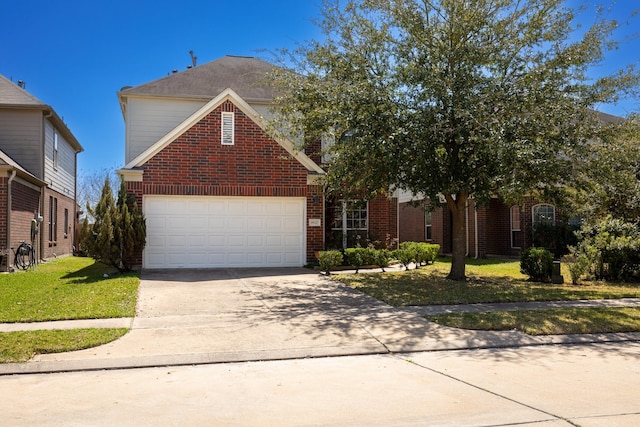 traditional-style home featuring brick siding, a garage, driveway, and a front lawn