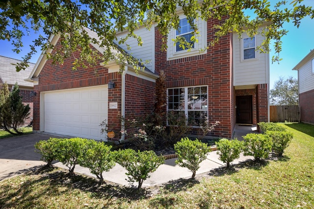 traditional-style home featuring a garage, a front lawn, fence, brick siding, and driveway
