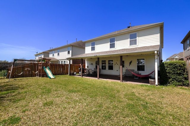 rear view of property featuring a fenced backyard, a lawn, a patio, and a playground