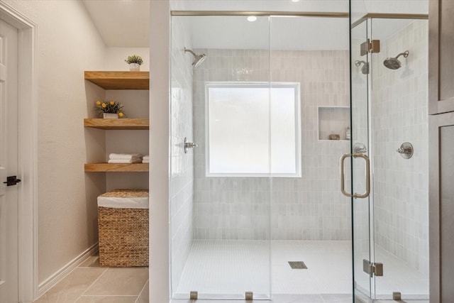full bath featuring tile patterned flooring and a stall shower