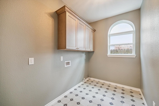 washroom with baseboards, cabinet space, tile patterned floors, and hookup for a washing machine