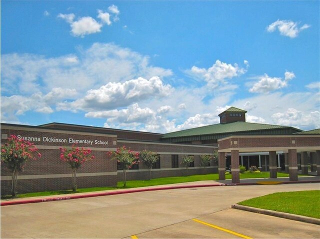 view of building exterior featuring uncovered parking