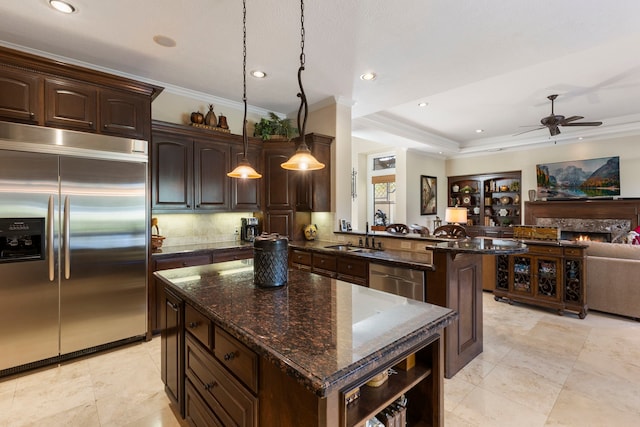 3034 Serena Vista Way, Houston, TX 77068 - kitchen featuring appliances with stainless steel finishes, crown molding, dark brown cabinetry, ceiling fan, and open floor plan