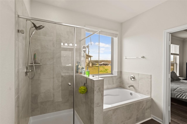 ensuite bathroom featuring a stall shower, ensuite bath, and a garden tub