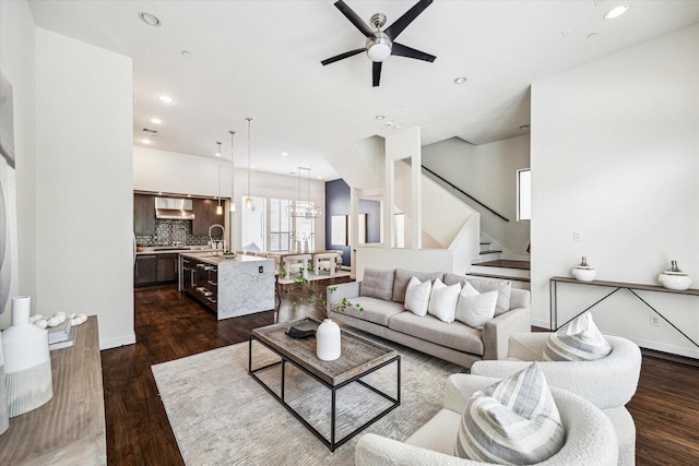 living area featuring stairway, recessed lighting, ceiling fan, and dark wood-style flooring