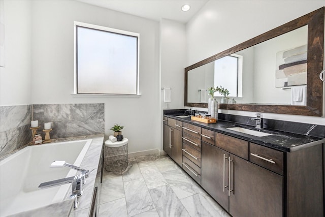 bathroom featuring a sink, a garden tub, double vanity, and marble finish floor