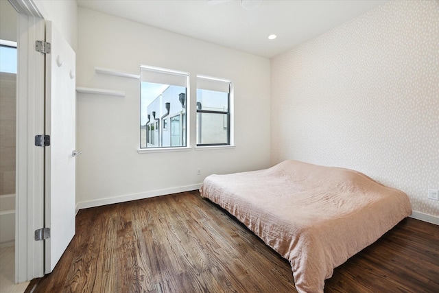 bedroom with recessed lighting, baseboards, wallpapered walls, and wood finished floors