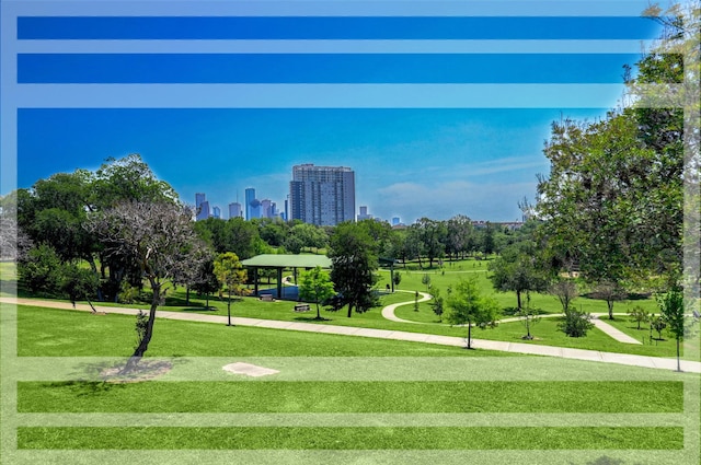 view of community with a view of city and a lawn