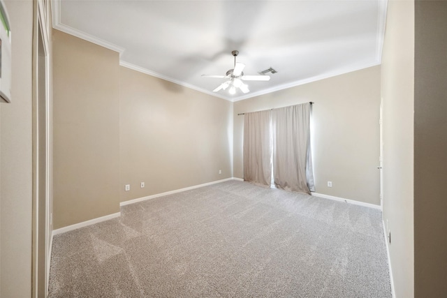 carpeted spare room featuring ceiling fan, visible vents, ornamental molding, and baseboards