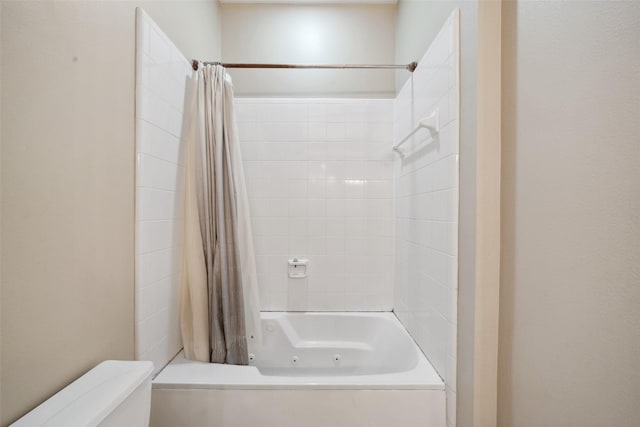 bathroom with toilet and shower / bath combination with curtain