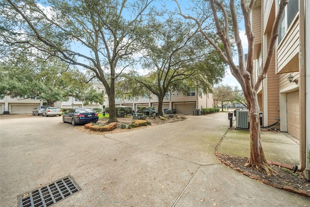 view of road featuring concrete driveway
