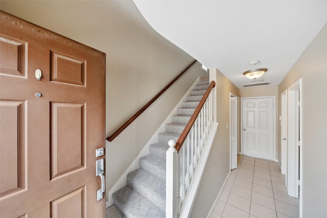 stairs with visible vents and tile patterned floors