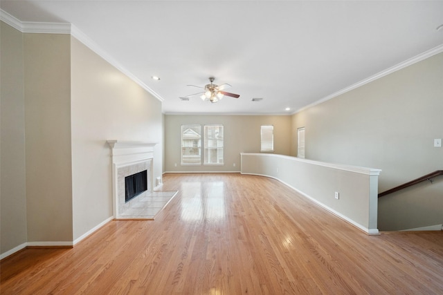 unfurnished living room featuring crown molding, a ceiling fan, baseboards, and light wood finished floors