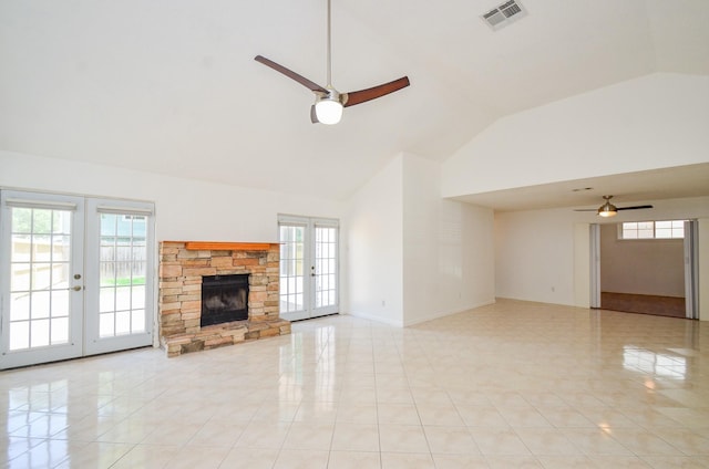 unfurnished living room with french doors, high vaulted ceiling, a ceiling fan, and a healthy amount of sunlight