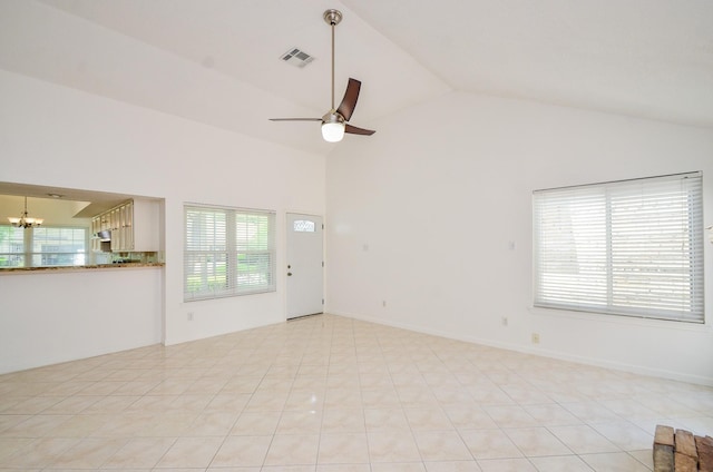 unfurnished living room featuring high vaulted ceiling, ceiling fan with notable chandelier, and visible vents