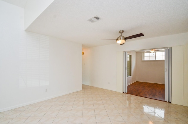 unfurnished room featuring visible vents and a ceiling fan