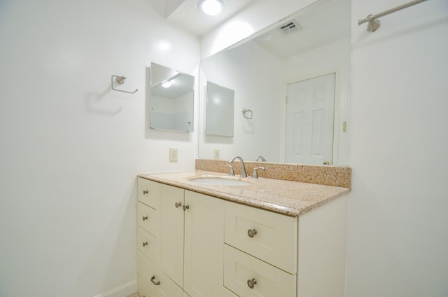 bathroom featuring visible vents and vanity