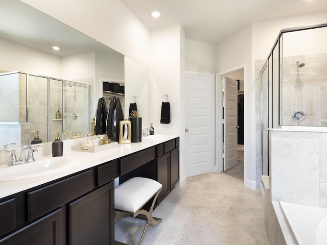 12130 Meandering Stream Dr, Baytown, TX 77523 - bathroom featuring double vanity, a sink, a walk in closet, and a shower stall