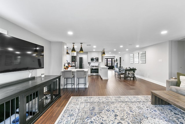 1609 Tabor St, Houston, TX 77009 - living room featuring baseboards, recessed lighting, and dark wood-style floors